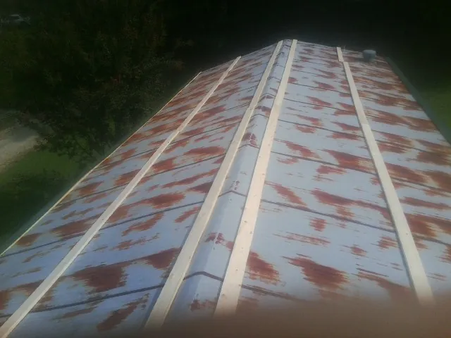 Rusted metal roof panels with new wood purlins before replacement — Storm Damage Roof Repair in Pala by Roofing Brothers