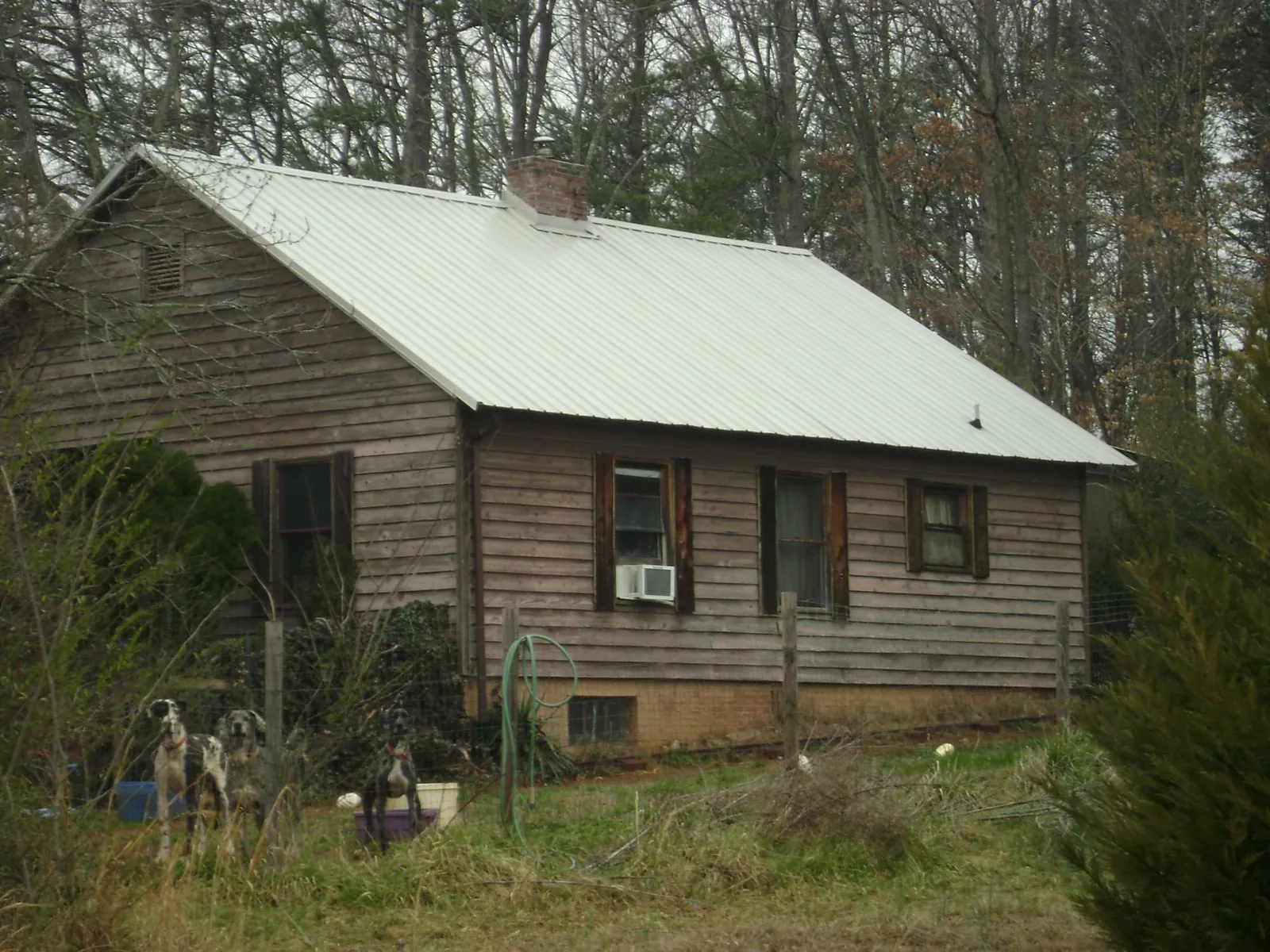 White metal roof on an old wood sided farmhouse, from a Metal Roof Installation job in Pala
